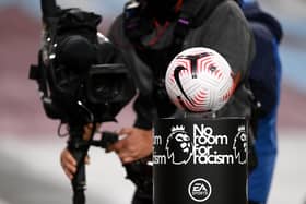 A TV cameraman films the match ball as it is displayed on a No Room for Racism plinth prior to the Premier League match between Burnley and Tottenham Hotspur at Turf Moor