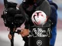 A TV cameraman films the match ball as it is displayed on a No Room for Racism plinth prior to the Premier League match between Burnley and Tottenham Hotspur at Turf Moor