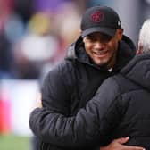 BURNLEY, ENGLAND - NOVEMBER 04: Vincent Kompany, Manager of Burnley, and Roy Hodgson, Manager of Crystal Palace, embrace prior to the Premier League match between Burnley FC and Crystal Palace at Turf Moor on November 04, 2023 in Burnley, England. (Photo by Nathan Stirk/Getty Images)