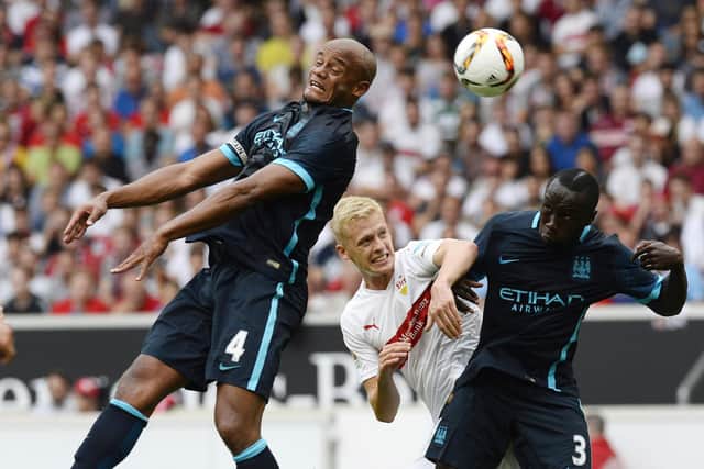 Stuttgart's defender Timo Baumgartl (C) vies for the ball with Manchester's defender Vincent Kompany (L) and Manchester's French defender Bacary Sagna during the friendly football match between VfB Stuttgart and Manchester City in Stuttgart, southern Germany, on August 1, 2015. AFP PHOTO / THOMAS KIENZLE        (Photo credit should read THOMAS KIENZLE/AFP via Getty Images)