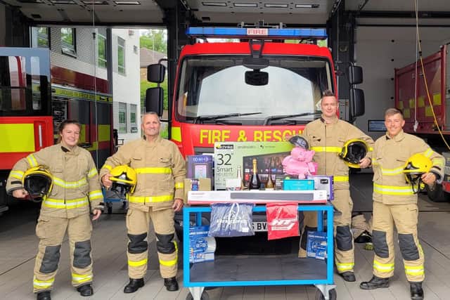 Crews at Burnley Fire Station with some of the prizes up for grabs at the open day next Saturday
