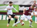 Burnley's English striker Jay Rodriguez (R) is pressured by Sheffield United's English-born Northern Irish midfielder Oliver Norwood (L) during the English Premier League football match between Burnley and Sheffield United at Turf Moor in Burnley, north west England on July 5, 2020.