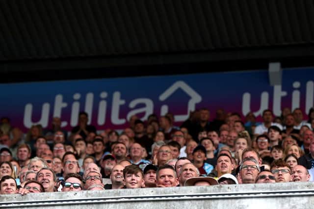 Fans watch on during the Premier League match between Burnley and Leeds United. (Photo by George Wood/Getty Images)