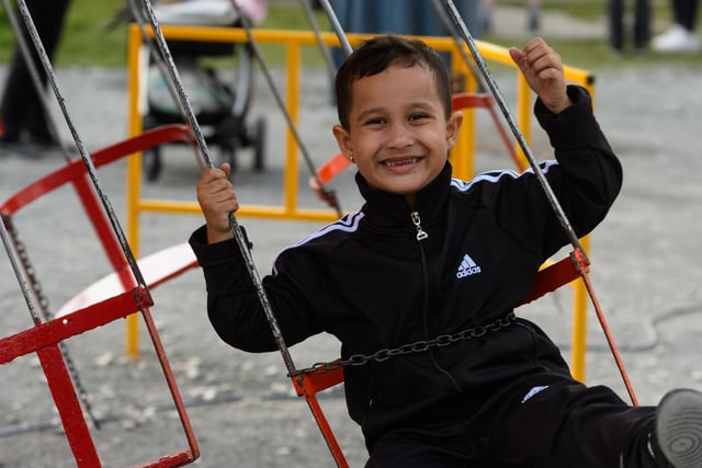 Ivan (4) enjoys the swings at Burnley fun fair at Towneley Park.