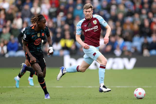 BURNLEY, ENGLAND - MARCH 05: Nathan Collins of Burnley runs with the ball from Trevoh Chalobah of Chelsea during the Premier League match between Burnley and Chelsea at Turf Moor on March 05, 2022 in Burnley, England. (Photo by Lewis Storey/Getty Images)