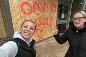 Charlatte's owner Charlotte Forrester (right) with coffee shop assistant Katie Broomfield and the sign they posted in defiance of vandals who smashed their shop window in the early hours of yesterday morning