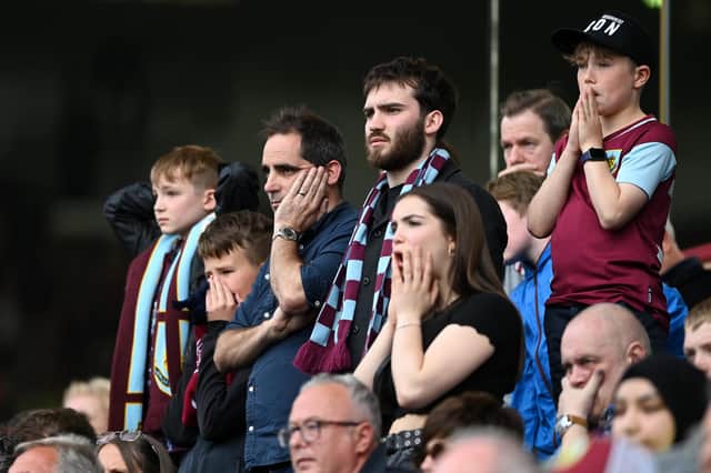 BURNLEY, ENGLAND - MAY 22: Burnley fans looks dejected following defeat and relegation to the Sky Bet Championship following the Premier League match between Burnley and Newcastle United at Turf Moor on May 22, 2022 in Burnley, England. (Photo by Gareth Copley/Getty Images)