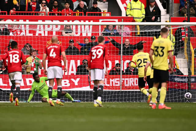 Burnley's Swiss striker #25 Zeki Amdouni (rear R) shoots a penalty kick and scores his team first goal during the English Premier League football match between Manchester United and Burnley at Old Trafford in Manchester, north west England, on April 27, 2024. (Photo by Oli SCARFF / AFP)