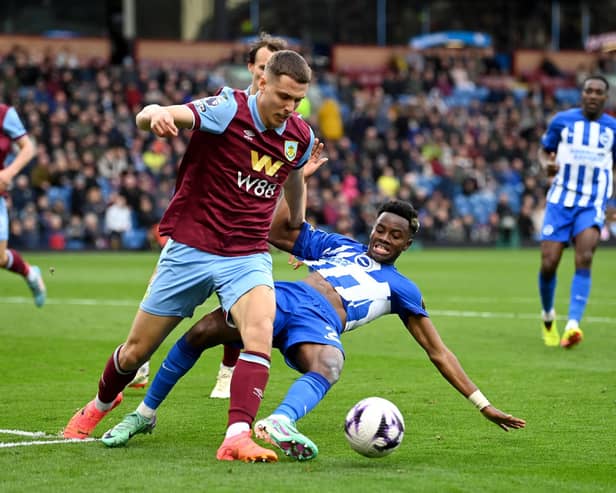 BURNLEY, ENGLAND - APRIL 13: Maxime Esteve of Burnley challenges Simon Adingra of Brighton & Hove Albion during the Premier League match between Burnley FC and Brighton & Hove Albion at Turf Moor on April 13, 2024 in Burnley, England. (Photo by Gareth Copley/Getty Images) (Photo by Gareth Copley/Getty Images)