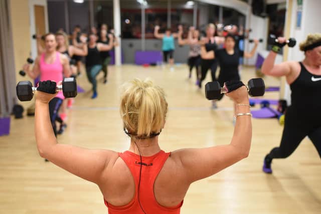 Gym-goers are put through their paces by a fitness instructor at Roefield Leisure Centre
