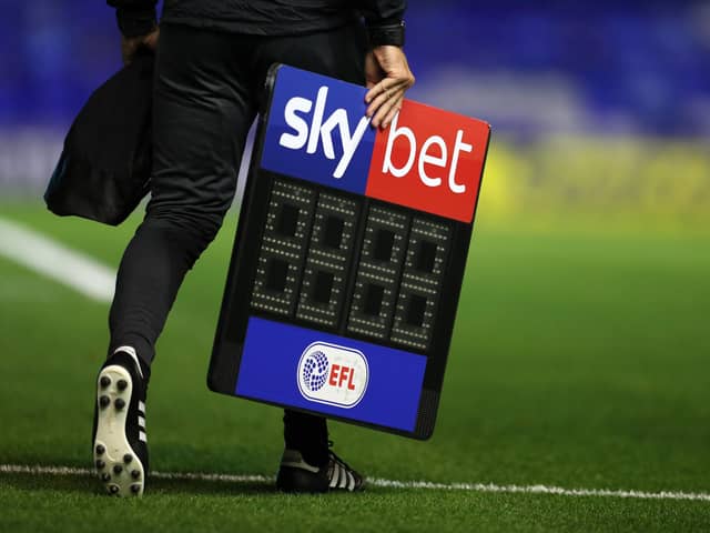 BIRMINGHAM, ENGLAND - SEPTEMBER 18: The fourth official carrys the Sky Bet EFL substitutes board across the pitch ahead of the Sky Bet Championship match between Coventry City and Queens Park Rangers at St Andrew's Trillion Trophy Stadium on September 18, 2020 in Birmingham, England. (Photo by Catherine Ivill/Getty Images)