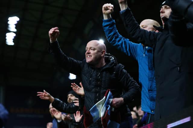 BURNLEY, ENGLAND - FEBRUARY 23: Burnley fans celebrate after their sides victory during the Premier League match between Burnley and Tottenham Hotspur at Turf Moor on February 23, 2022 in Burnley, England. (Photo by Alex Livesey/Getty Images)