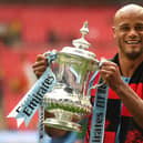Manchester City's Belgian captain Vincent Kompany holds the winner's trophy after the English FA Cup final football match between Manchester City and Watford at Wembley Stadium in London, on May 18, 2019. - Manchester City beat Watford 6-0 at Wembley to claim the FA Cup.