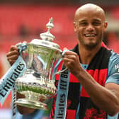 Manchester City's Belgian captain Vincent Kompany holds the winner's trophy after the English FA Cup final football match between Manchester City and Watford at Wembley Stadium in London, on May 18, 2019. - Manchester City beat Watford 6-0 at Wembley to claim the FA Cup.