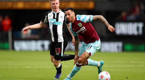 BURNLEY, ENGLAND - MAY 22: Dwight McNeil of Burnley on the ball whilst under pressure from Matt Targett of Newcastle United during the Premier League match between Burnley and Newcastle United at Turf Moor on May 22, 2022 in Burnley, England. (Photo by Jan Kruger/Getty Images)
