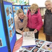 Stephanie Richards (left) explains some of the items on display in Cliviger