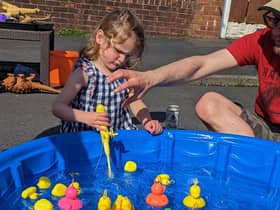 Imogen Salisbury plays Hook a Duck during a Clitheroe street party to celebrate the king's coronation.