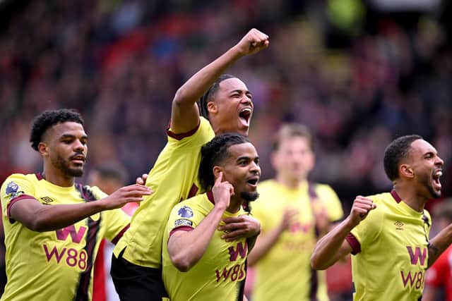 SHEFFIELD, ENGLAND - APRIL 20: Lyle Foster of Burnley celebrates scoring his team's third goal with teammates Wilson Odobert and Lorenz Assignon of Burnley during the Premier League match between Sheffield United and Burnley FC at Bramall Lane on April 20, 2024 in Sheffield, England. (Photo by Stu Forster/Getty Images)
