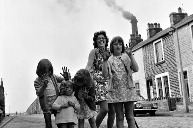 Mrs jEAN Birkett tries to see a funny side of the situation as children show their sooty hands and the offending chimney looms in the background.
Burnley's Chief Public Health Inspector has taken up the case of the smoky pit chimney. This follows complaints from residents in the Thursby Road area that they have been out with brushes two mornings this week to clear soot which has been falling on the road, walls, cars and gardens. Salvage operations are being carried out at Bank Hall Colliery.