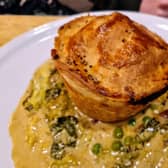 The Chef's famous chicken and ham hock pie served with creamed cabbage, peas, bacon and chips at the Four Alls Inn, Higham