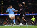 MANCHESTER, ENGLAND - MARCH 18: Lyle Foster of Burnley is challenged by Rico Lewis of Manchester City during the Emirates FA Cup Quarter Final match between Manchester City and Burnley at Etihad Stadium on March 18, 2023 in Manchester, England. (Photo by Michael Regan/Getty Images)