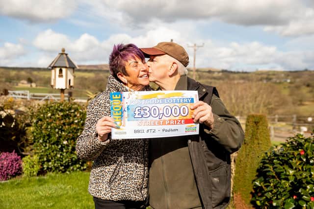 Lottery winners Bob and Margaret Atkinson seal their win with a kiss