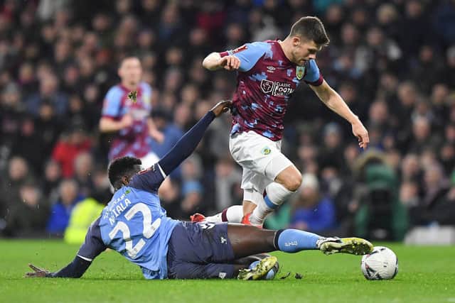 Burnley's Johann Guomundsson is tackled by Fleetwood Town's Aristote Nsiala

The Emirates FA Cup Fifth Round - Burnley v Fleetwood Town - Wednesday 1st March 2023 - Turf Moor - Burnley