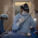 A surgeon performs an endoscopic surgery. (Photo by Rebecca Conway/Getty Images)