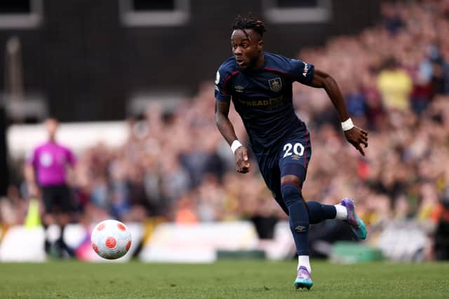 NORWICH, ENGLAND - APRIL 10: Maxwel Cornet of Burnley runs with the ball during the Premier League match between Norwich City and Burnley at Carrow Road on April 10, 2022 in Norwich, England. (Photo by Paul Harding/Getty Images)
