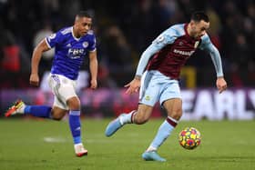 BURNLEY, ENGLAND - MARCH 01: Dwight McNeil of Burnley runs with the ball from Youri Tielemans of Leicester City during the Premier League match between Burnley and Leicester City at Turf Moor on March 01, 2022 in Burnley, England. (Photo by Lewis Storey/Getty Images)