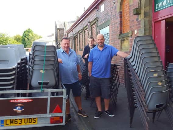 Furniture for Education Worldwide chairman Terry Burns (left) with charity volunteers, takes delivery of the chairs destined for Tanzania from St Cuthbert's Operatic Society.