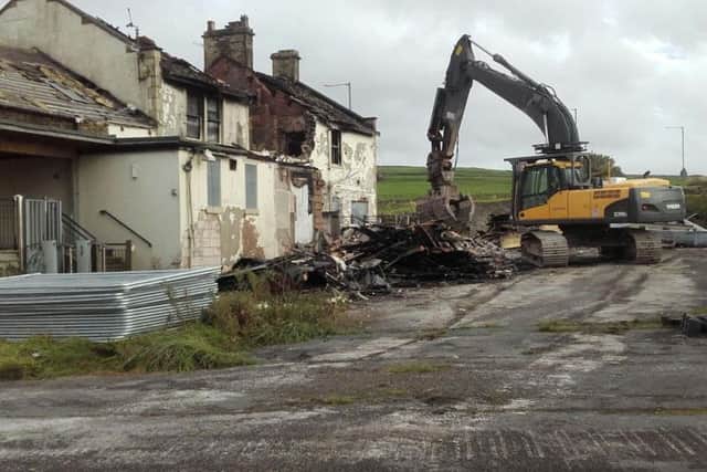 The bulldozer moves in to demolish the rear of the Bull and Butcher in this shot taken by reader Mrs Hazel Wilkinson.