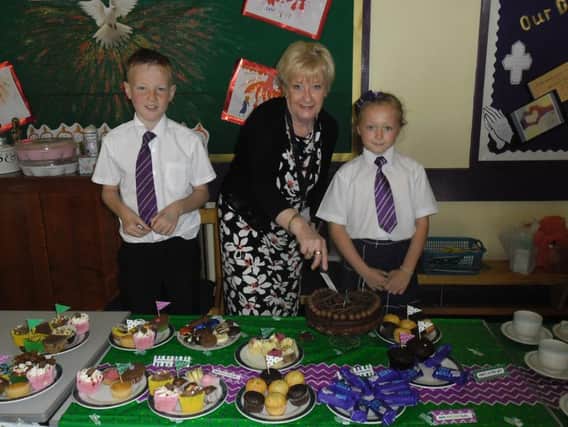 Secretary Mrs Freda White with pupils Lucas Brodie and Petal Bates at the Macmillan coffee morning at St Mary Magdalene's Primary School in Burnley