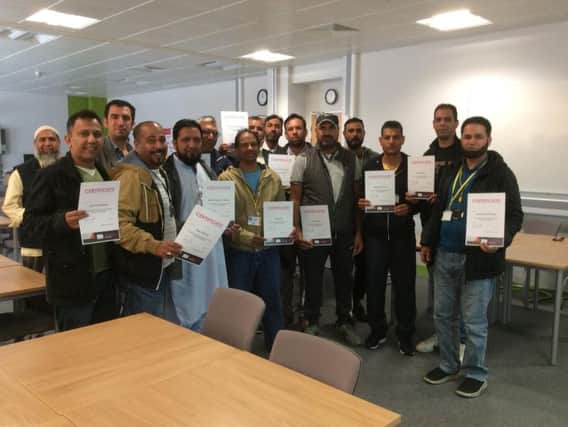A group of successful Burnley taxi driver candidates are presented with their certificates (s)