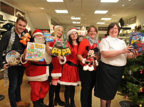 Pictured at the launch of the Christmas Toy Appeal are (left to right) reporter Jack Marshall with  volunteers at the Salvation Army shop in Burnley, Rachel Lee, Tammy Porton,  Captain Maisie Veacock, Andrea Harrison and Tracey Lee
