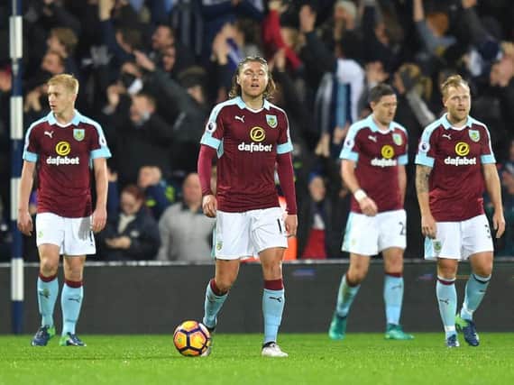 Burnley players trudge back to the halfway line after conceding
