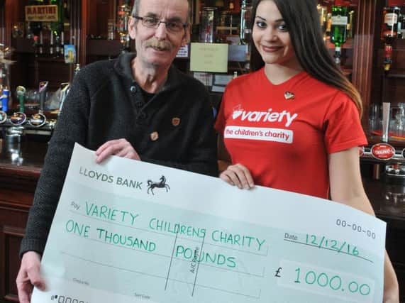 Mick Igoe from Burnley Miners' Club and Katie Taylor, a presenter from Gala Bingo, with a cheque for the money raised for the Variety Club.