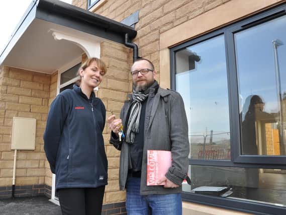 (Left) Kathryn Davies, Neighbourhood Officer for Calico, hands over the keys to resident Tomasz Marzecs new home.