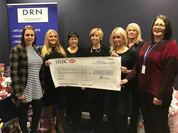 Representatives from Young Carers accepts the cheque from DRN Law.