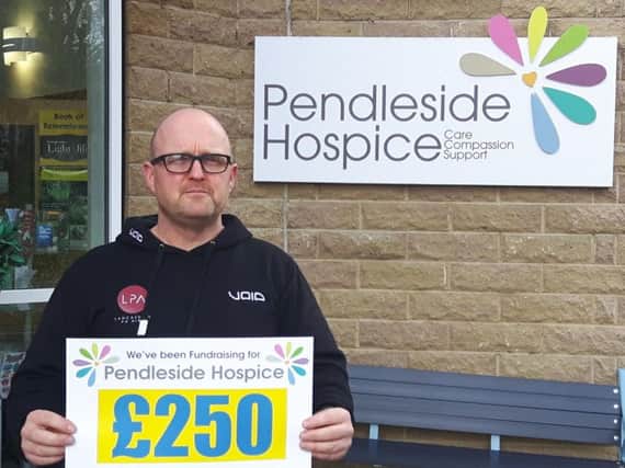 Lancashire PA owner Darryl Fraser with a cheque for the money he raised for Pendleside Hospice at a House music night.