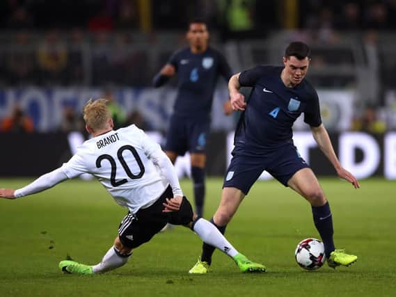 Michael Keane takes on Julian Brandt in Dortmund on his England debut