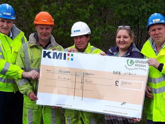 Pendleside Hospice fund raiser Sammi Graham receives the cheque from (left to right) Tony Doherty (site manager), Simon Dodd, Jimmy Crosby and Colin Nicholson (general foreman)
