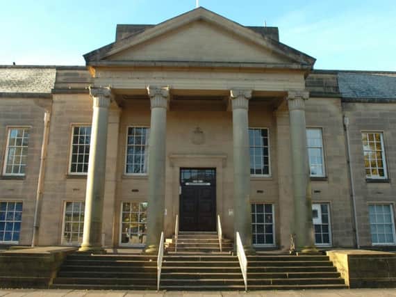 Burnley magistrates heard how a store manager and two of her colleagues were threatened with a syringe by a drug addict