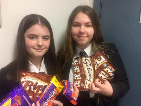 Madison Holmes (right) and her friend Megan Griffiths, collect chocolate and sweets for their fund raising stall for victims of the Manchester bomb attack.