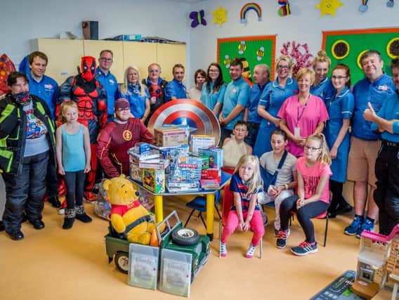 The superheroes handed over toys to patients at Blackburn hospital
