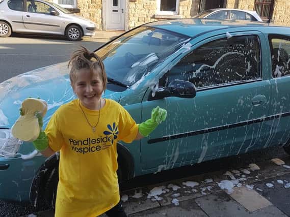 Amelia has been washing the cars of friends and family to raise the funds.