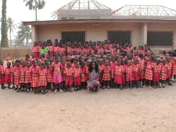 Maria with some of the pupils at the Marinel School in Ghana that is to receive computers recycled by a Padiham company.