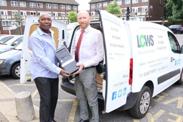 Daniel Jolly, (right) the national client manager for LCWS presents the computer equipment to Mr Theophilus Nelson, founder of the Marinel School in Ghana.