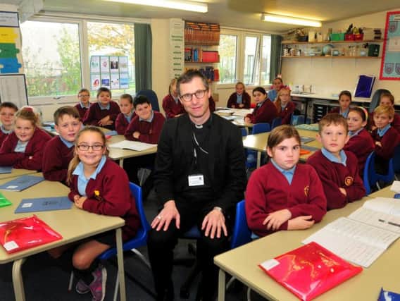 The Bishop of Burnley prepares to be questioned by  pupils at Holy Trinity Primary School in Burnley.