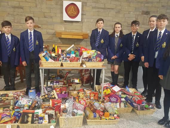 Students at Blessed Trinity with a selection of donations for their Christmas hampers.